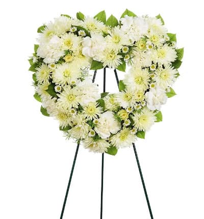 Express heartfelt thoughts of sympathy in a special way with this open heart standing wreath made of carnations, cushion, roses and Monte Casino blooms on a wire easel.

Includes:
* White Roses (Deluxe & Premium)
* White Carnations
* Cushion Poms
* Open Heart Shape