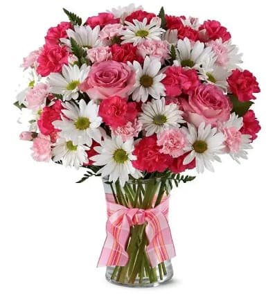 * Hot Pink Spray Roses
* White Traditional Daisies
* Pink Mini Carnations
* Clear Vase with Pink Bow